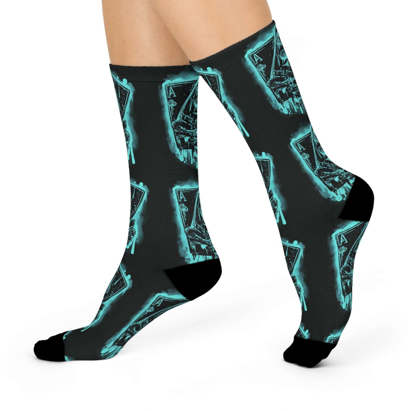 Pair of crew socks with a glowing blue neon aces of spades design held in skeletal hands. Socks are shown on model's feet in a casual stance. Dark gray background. (Keywords: poker socks, aces socks, pocket aces socks, neon socks, comfortable socks, crew socks)